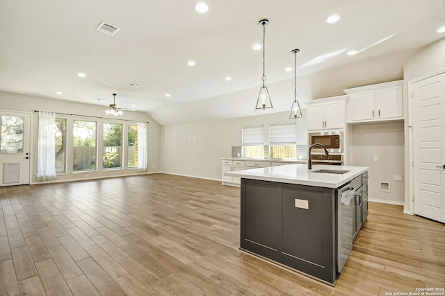 kitchen featuring a center island with sink, ceiling fan, appliances with stainless steel finishes, light hardwood / wood-style floors, and white cabinetry