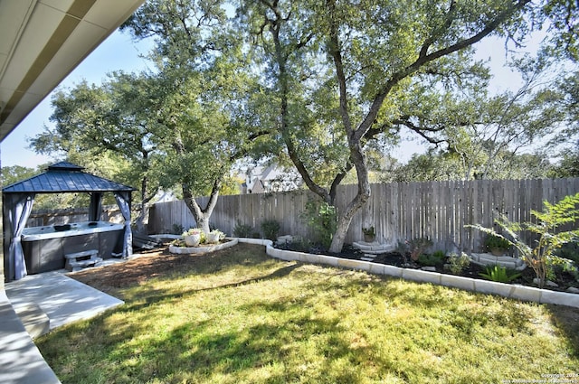 view of yard with a gazebo and a hot tub