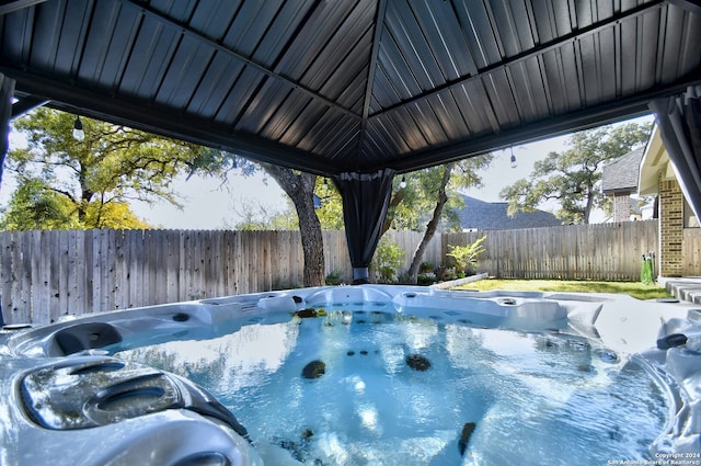 view of pool with a hot tub