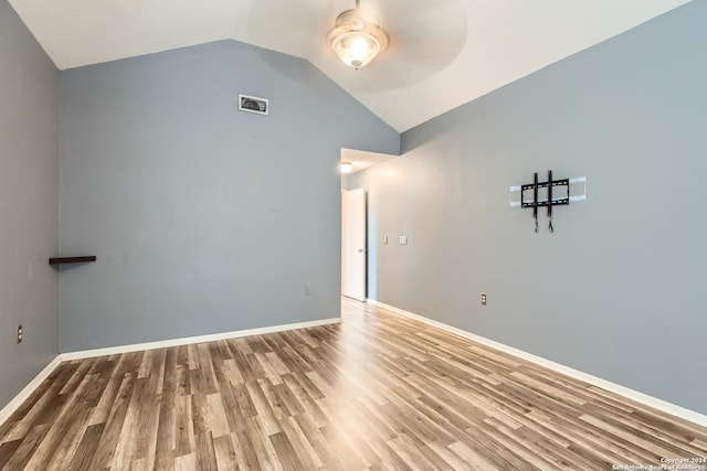 empty room with hardwood / wood-style floors, ceiling fan, and lofted ceiling