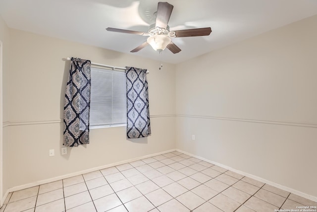 tiled spare room featuring ceiling fan