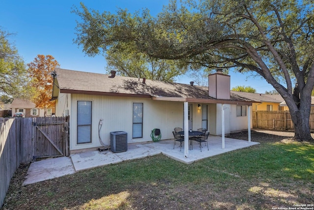 4911 Dare, San Antonio, TX 78217 - back of property with a lawn, a patio area, and central AC