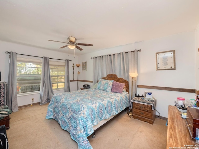 bedroom featuring ceiling fan and light carpet