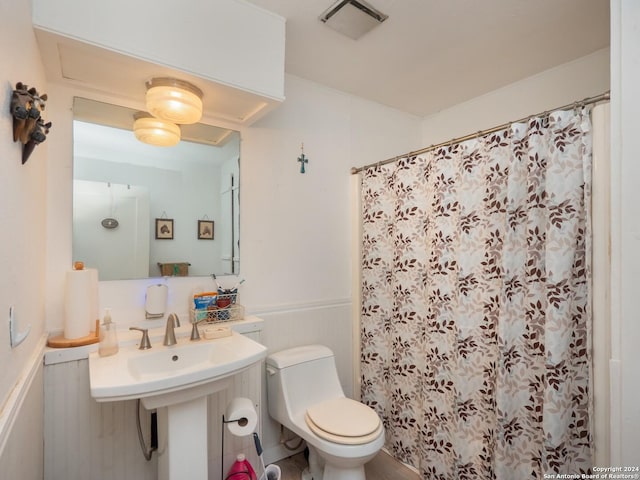 bathroom with a shower with curtain and toilet