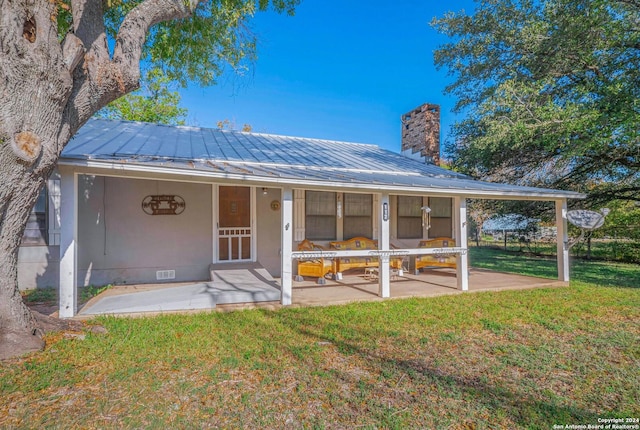 rear view of property with a lawn