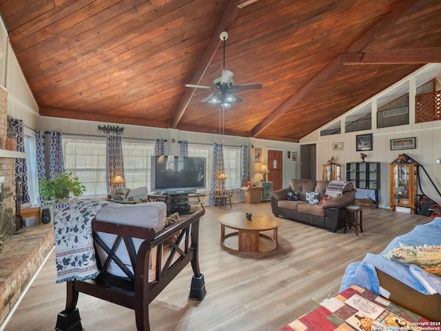 living room featuring beamed ceiling, light hardwood / wood-style flooring, ceiling fan, and wooden ceiling