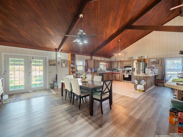 dining space featuring french doors, vaulted ceiling with beams, light hardwood / wood-style floors, and wood ceiling