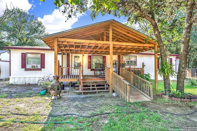 rear view of house featuring a porch