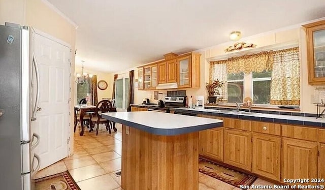 kitchen featuring appliances with stainless steel finishes, ventilation hood, light tile patterned floors, a chandelier, and a center island