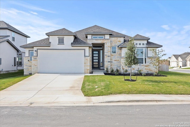 view of front of property with a garage and a front lawn