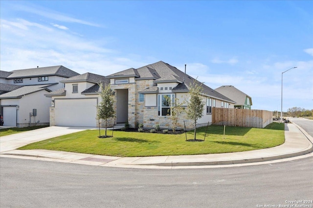 view of front of house with a garage and a front lawn