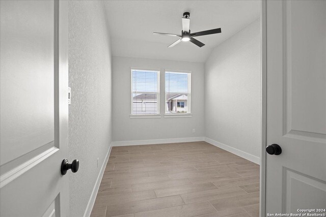 empty room with ceiling fan and light wood-type flooring