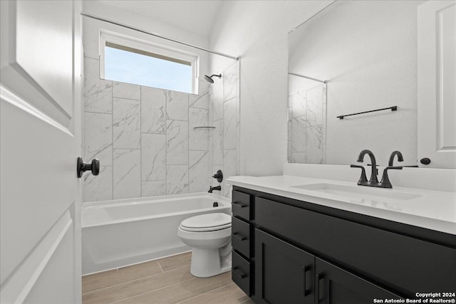 full bathroom featuring vanity, toilet, and tiled shower / bath