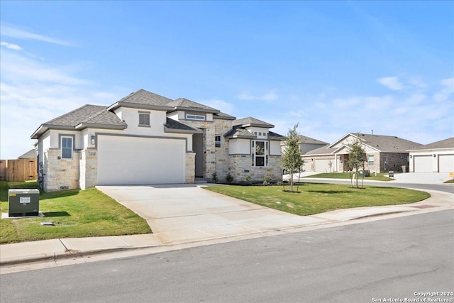 view of front of property featuring a front yard and a garage