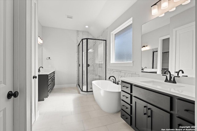 bathroom featuring tile patterned flooring, vanity, and separate shower and tub