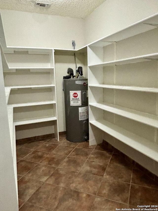 utility room featuring water heater