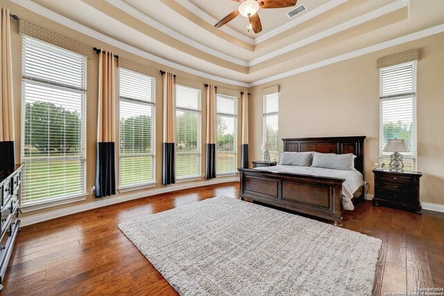 bedroom with dark wood-type flooring and multiple windows