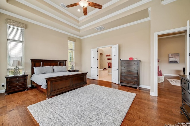 bedroom with connected bathroom, ceiling fan, hardwood / wood-style floors, and ornamental molding