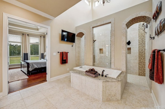 bathroom featuring wood-type flooring, separate shower and tub, and ornamental molding