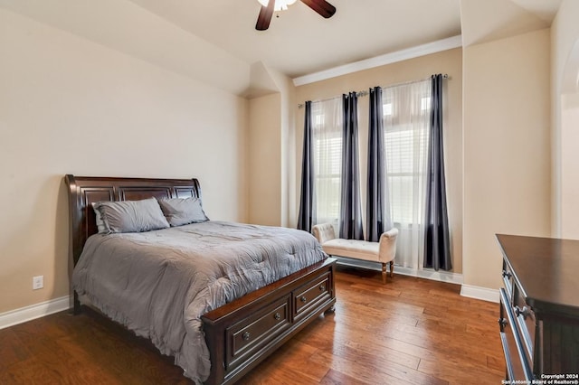 bedroom with dark hardwood / wood-style floors, ceiling fan, and ornamental molding