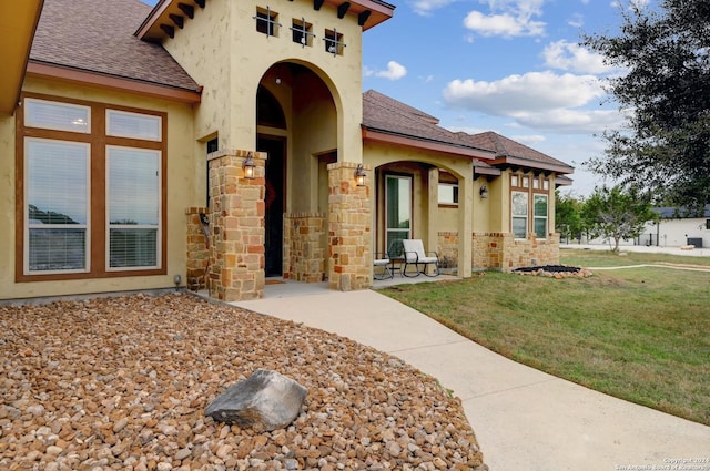 doorway to property with a yard