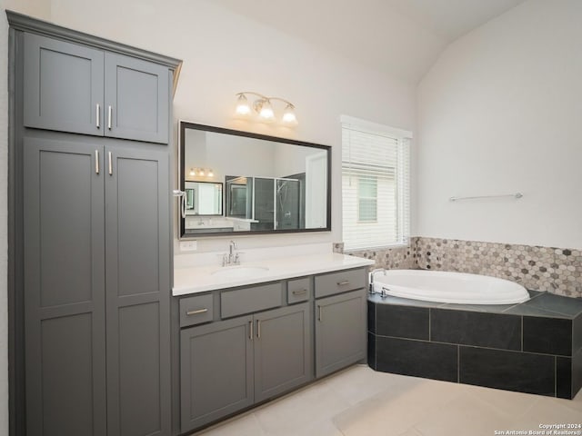 bathroom featuring tile patterned floors, vanity, independent shower and bath, and lofted ceiling