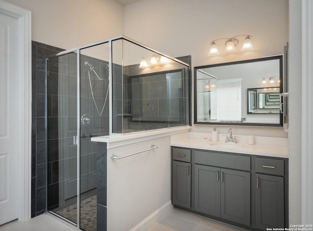 bathroom with tile patterned floors, vanity, and walk in shower