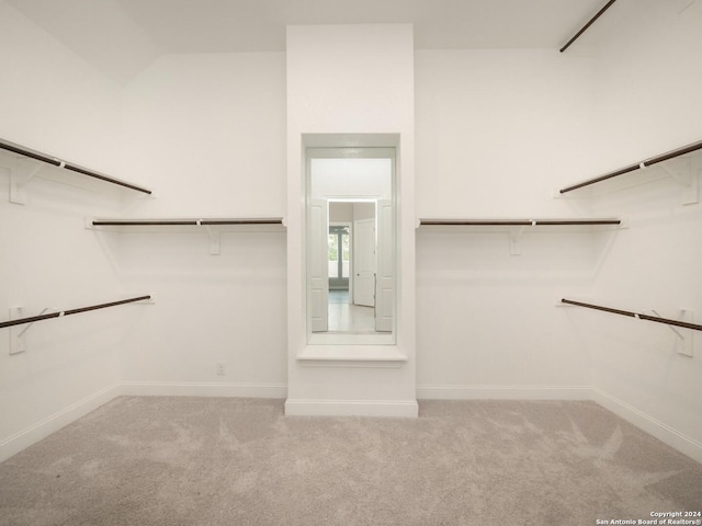 spacious closet featuring light carpet