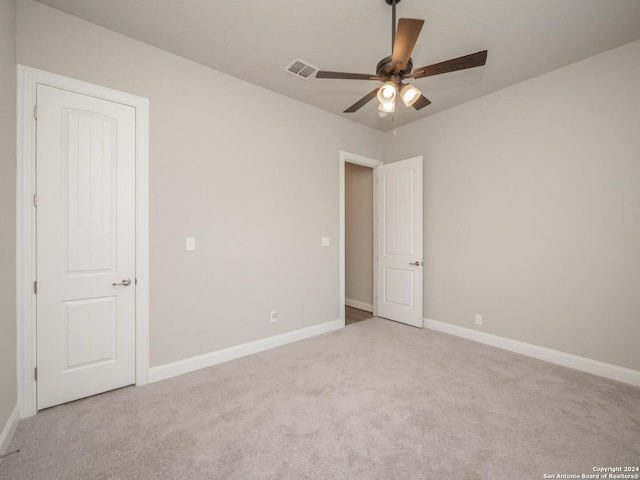 carpeted empty room with ceiling fan