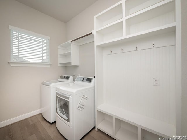 clothes washing area featuring washing machine and dryer and dark wood-type flooring