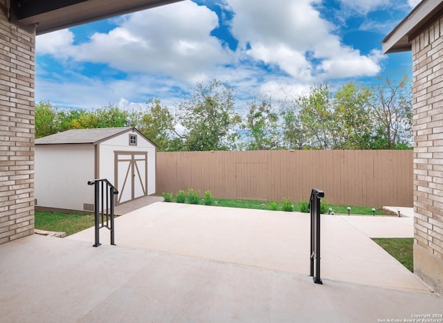 view of patio / terrace featuring a storage unit