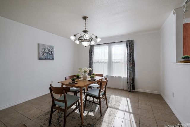 tiled dining room with a textured ceiling and a notable chandelier