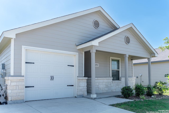 view of front of property featuring a porch and a garage