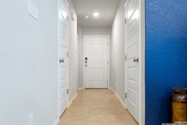 corridor featuring light tile patterned flooring