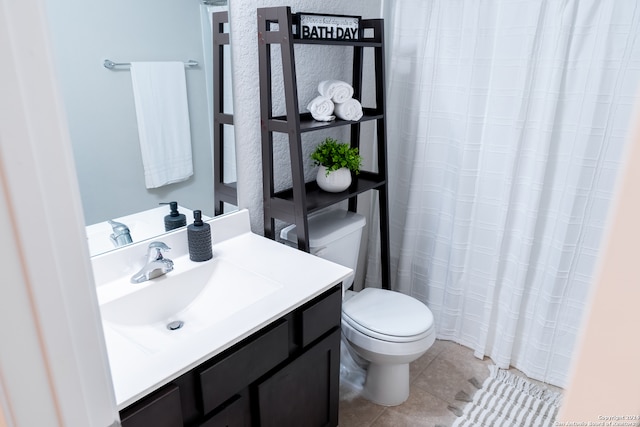 bathroom with tile patterned floors, vanity, and toilet