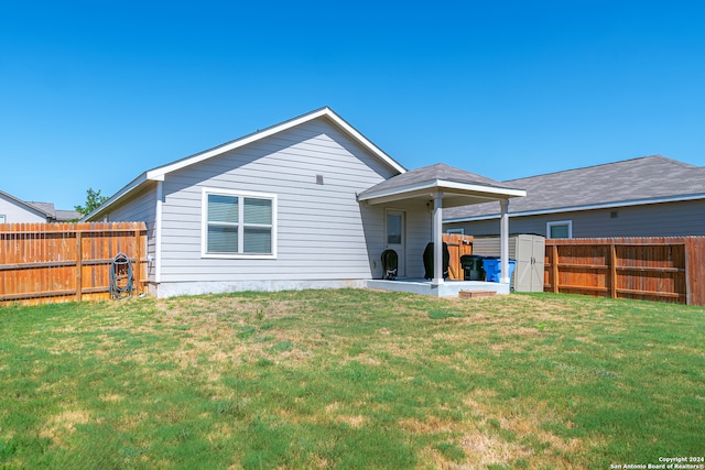 rear view of house with a yard