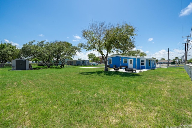 view of yard featuring a patio and a shed