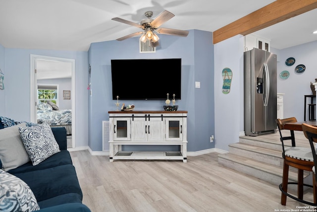 living room featuring lofted ceiling with beams, ceiling fan, and light hardwood / wood-style floors