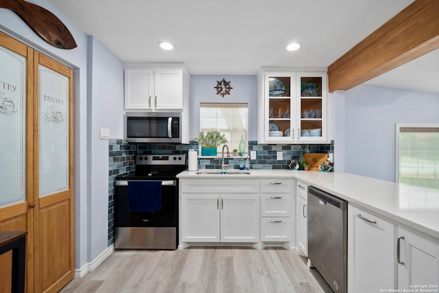 kitchen featuring sink, white cabinets, and appliances with stainless steel finishes