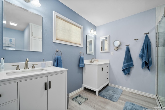 bathroom featuring wood-type flooring, vanity, and an enclosed shower