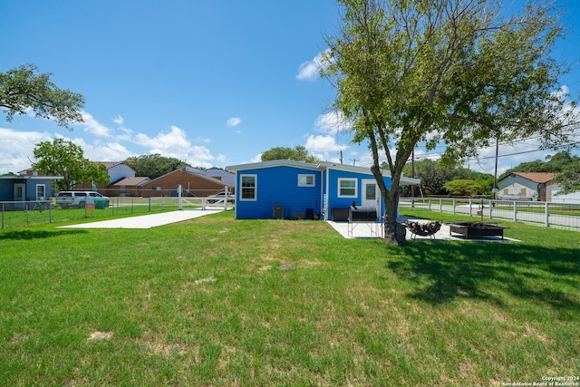 back of house with a lawn