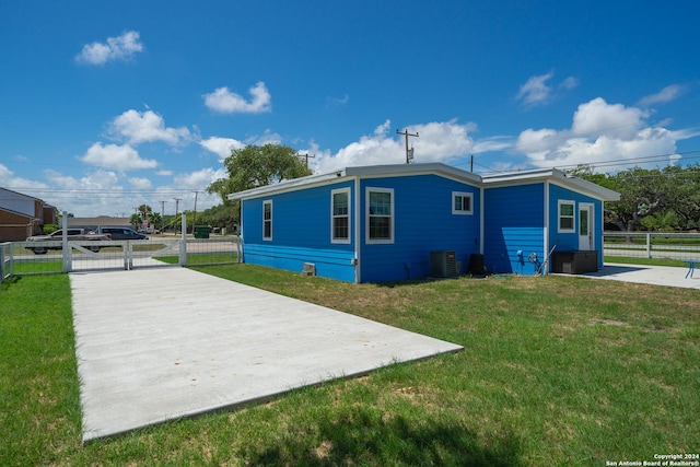 view of property exterior featuring a lawn, central air condition unit, and a patio