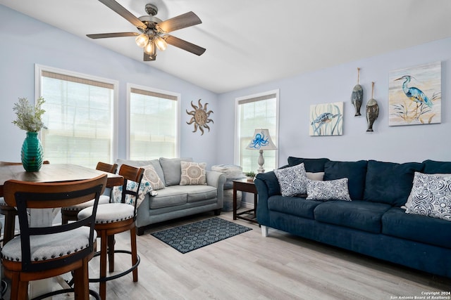 living room with ceiling fan, light hardwood / wood-style flooring, a healthy amount of sunlight, and lofted ceiling