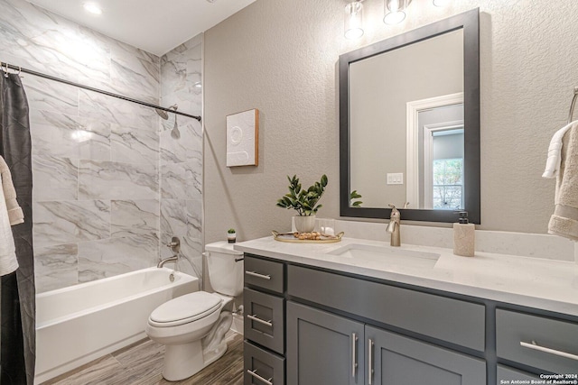 full bathroom with vanity, hardwood / wood-style floors, tiled shower / bath combo, and toilet