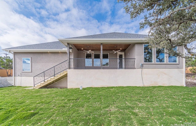 back of house with a lawn and ceiling fan