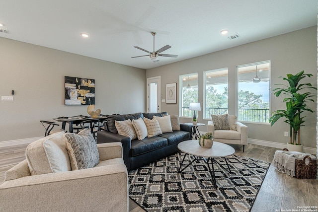 living room with light wood-type flooring and ceiling fan