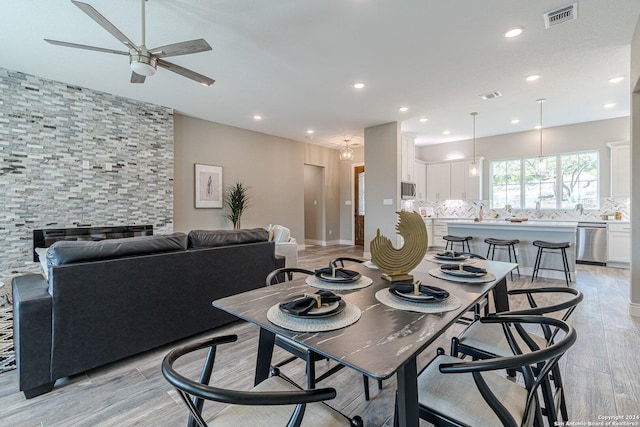 dining area featuring ceiling fan and light wood-type flooring