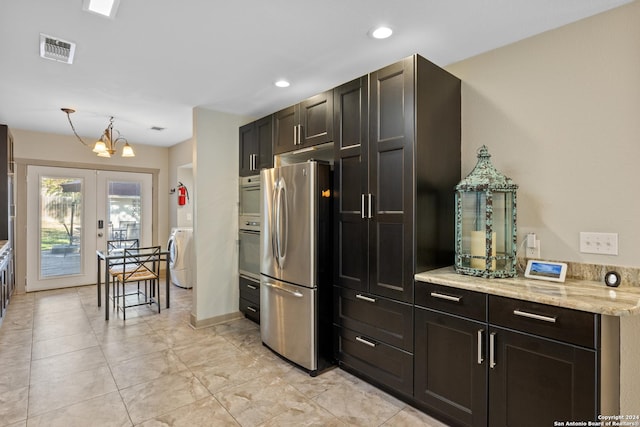 333 Redwood St, Alamo Heights, TX 78209 - kitchen with appliances with stainless steel finishes, french doors, washer / clothes dryer, a chandelier, and light stone countertops