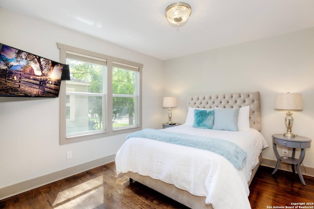 bedroom with dark wood-type flooring