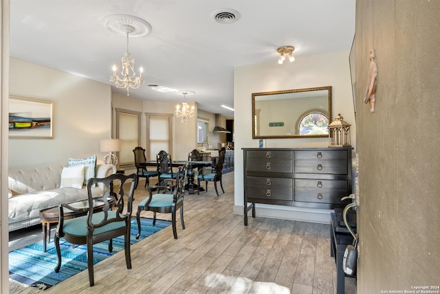 interior space featuring light hardwood / wood-style floors and a chandelier